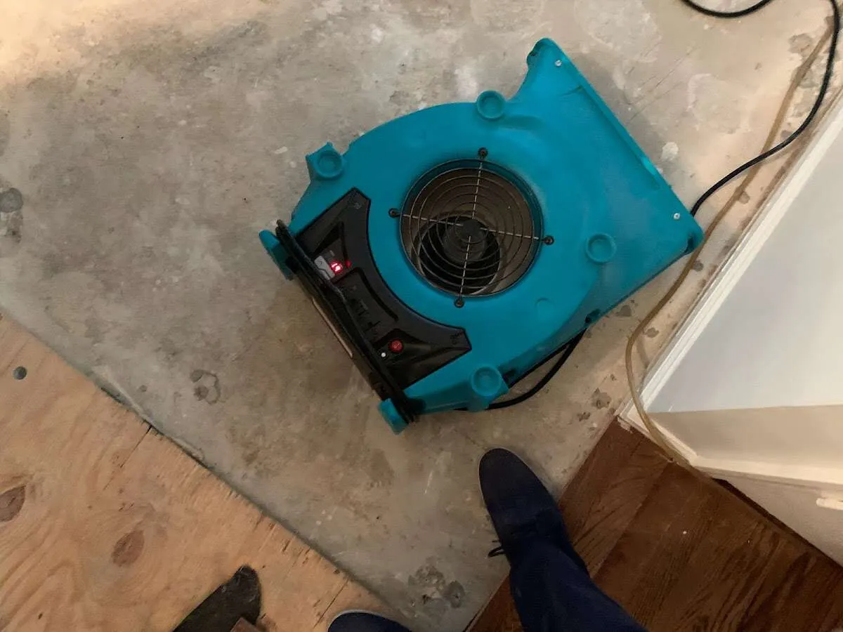 Air mover drying subfloor during Commercial Water Damage Restoration in Junction City